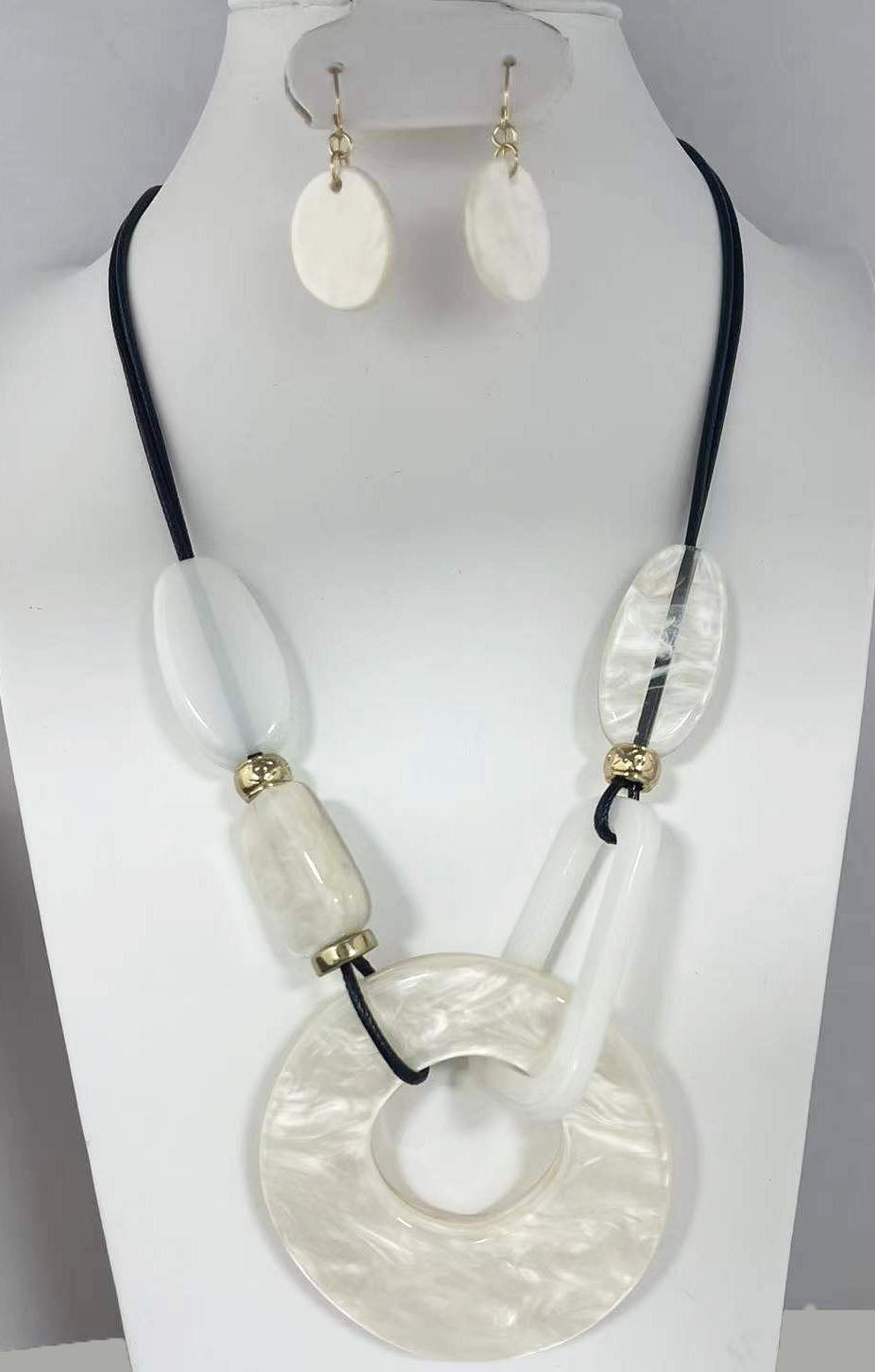 NE-140 White Lucite Orbs and Donut on Black Leather